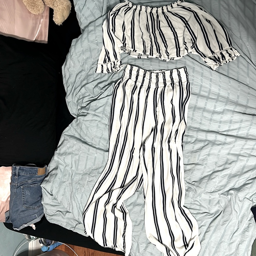 A romper with blue and white stripes perfect for a beach cover-up or a dinner.